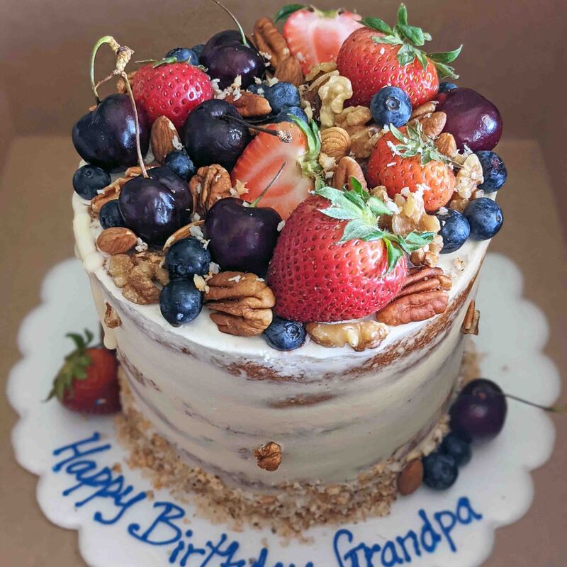 Naked cake topped with fruit and nuts